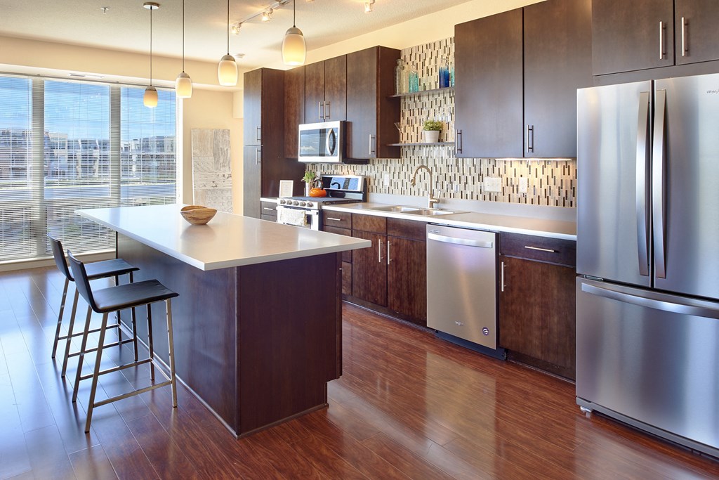 a large kitchen with stainless steel appliances and a counter top