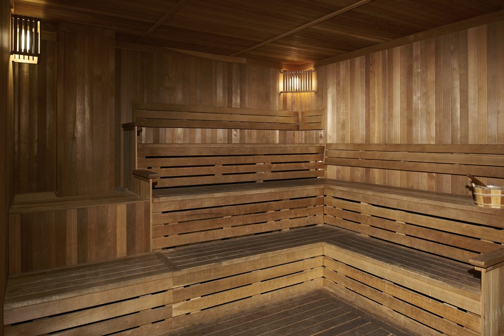 a large wooden sauna in a room with wooden walls and floors