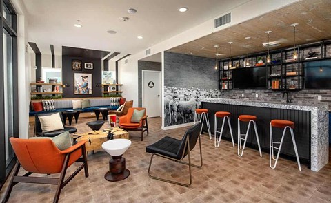 a lobby with a bar and tables and chairs