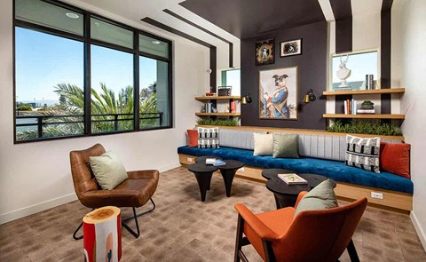 a living room with a blue couch and chairs