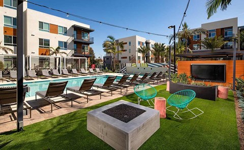 a swimming pool with lounge chairs and a television