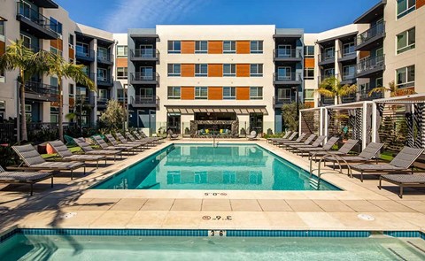 a swimming pool in front of an apartment building