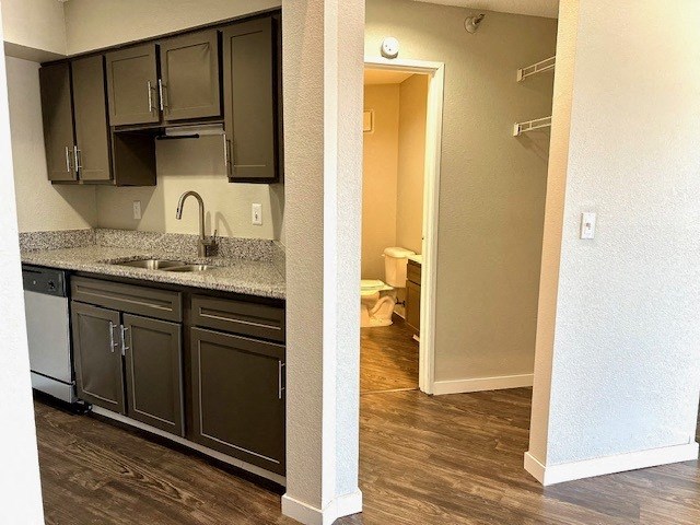 a kitchen with black cabinets and a sink