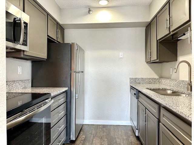 a kitchen with granite counter tops and stainless steel appliances