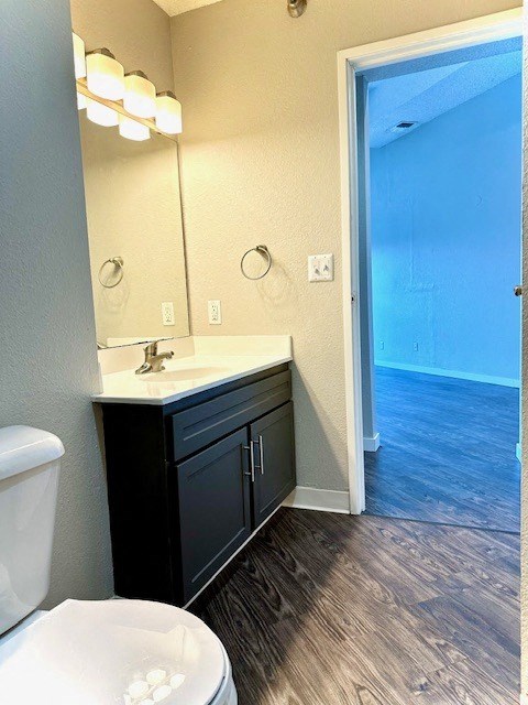 a bathroom with a toilet and a sink and a mirror