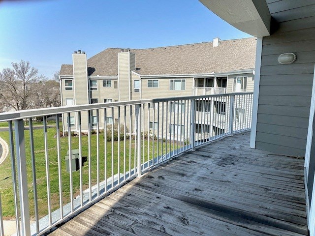 a view of a house from a balcony with a wooden deck