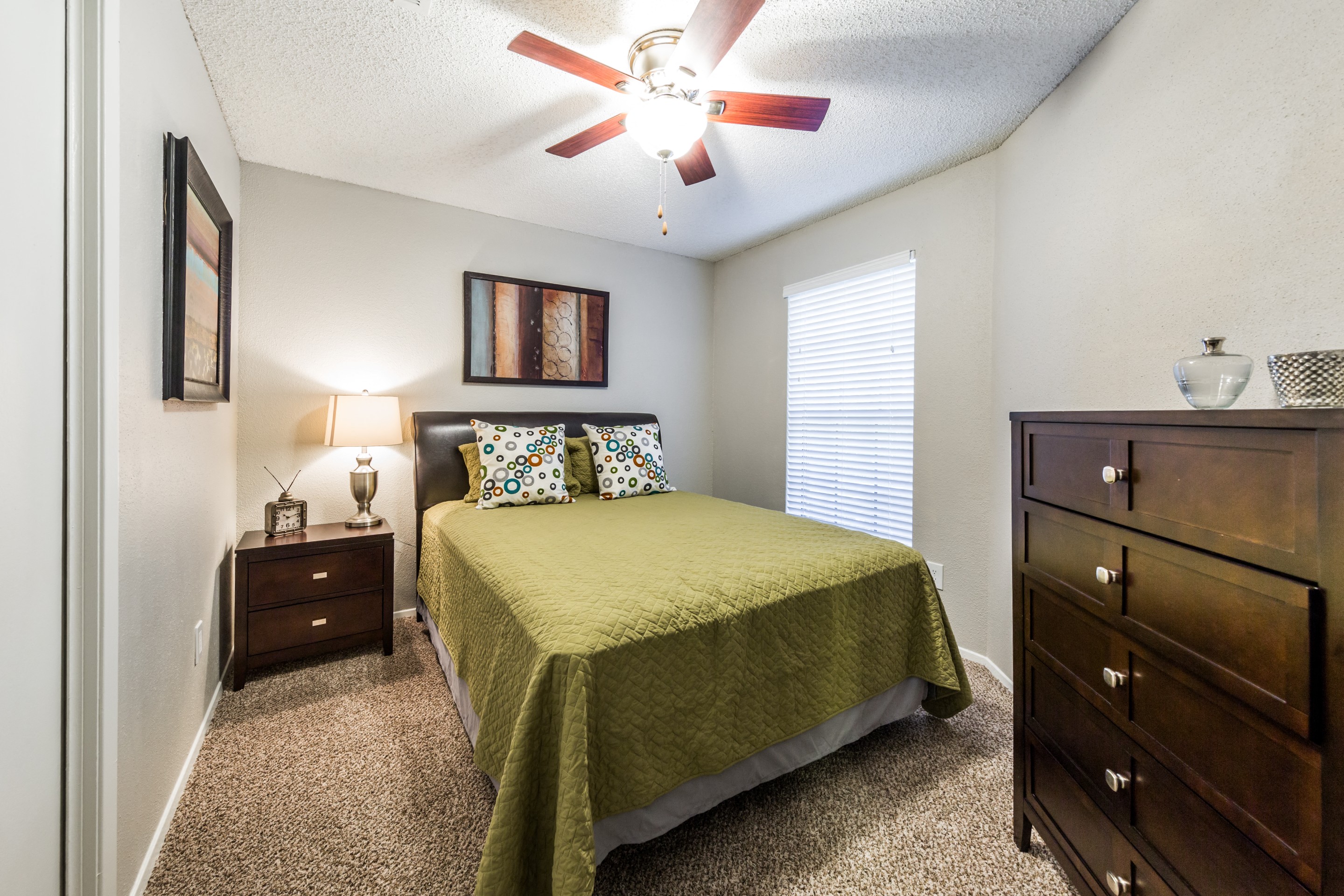 bedroom with large window and ceiling fan