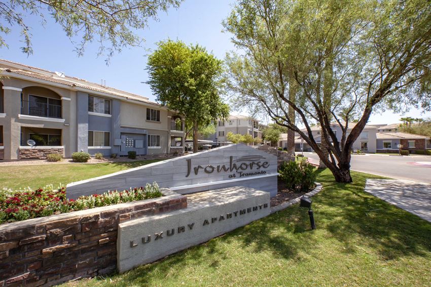 Apartments in North Phoenix AZ for Rent - Exterior View of Ironhorse at Tramonto Apartments Building Showcasing Entrance Sign and Expansive Community - Photo Gallery 1