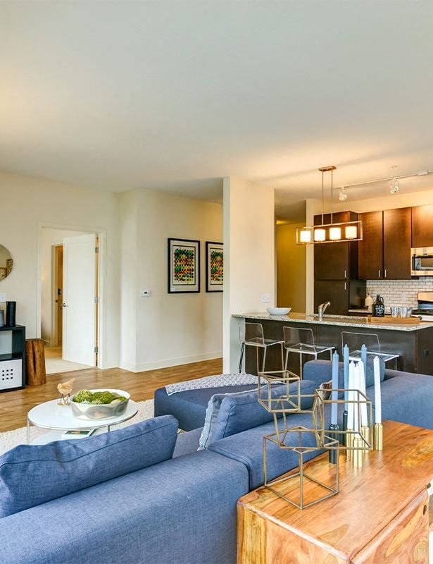 a living room with a blue couch and a table