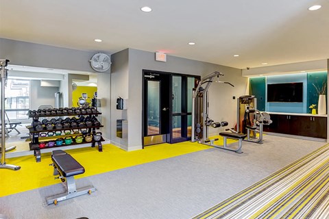 a gym with weights and other equipment in a building