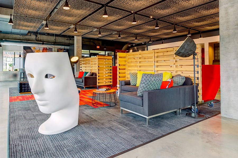 a living room with a large sculpture of a face