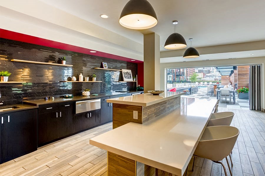 a kitchen with a long counter and a table and chairs