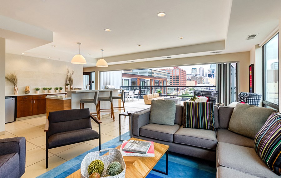 A living room with a couch, chairs, and a coffee table.