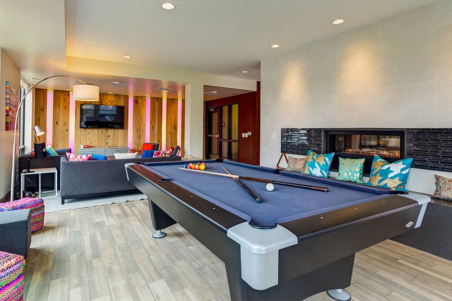 a game room with a pool table and a tv