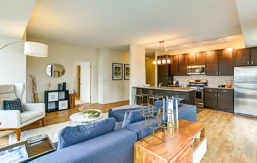 a living room and kitchen with a blue couch