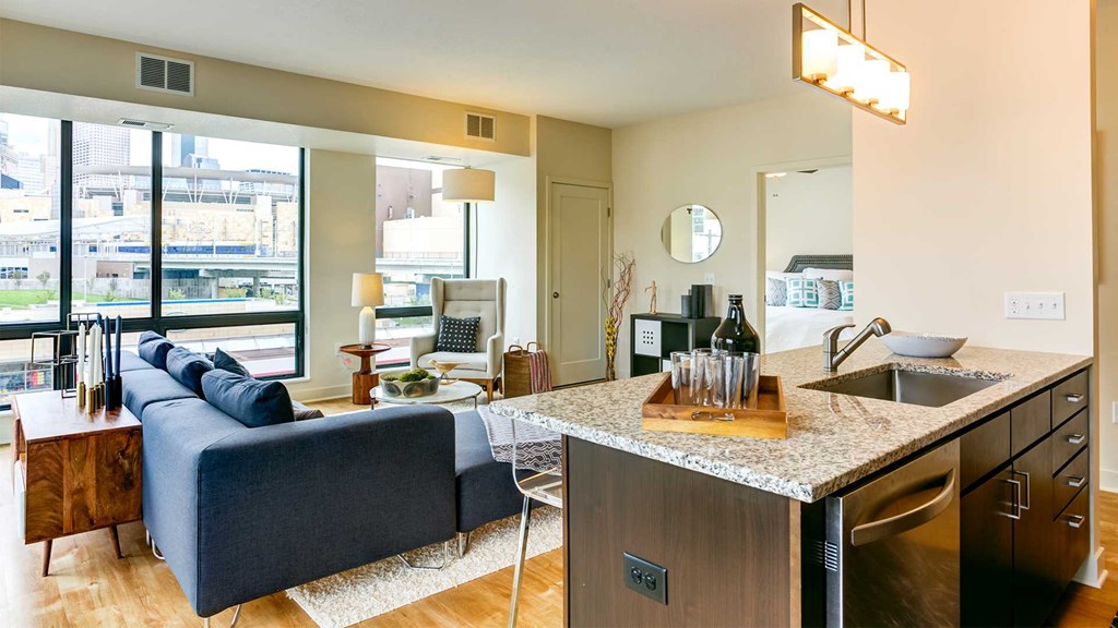a kitchen and living room with a counter top