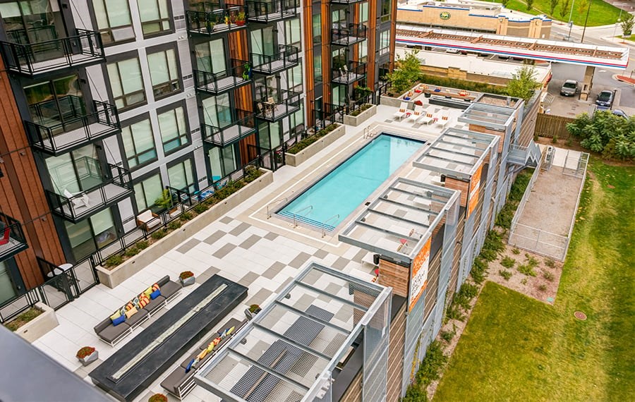 A modern building with a pool and a glass wall.
