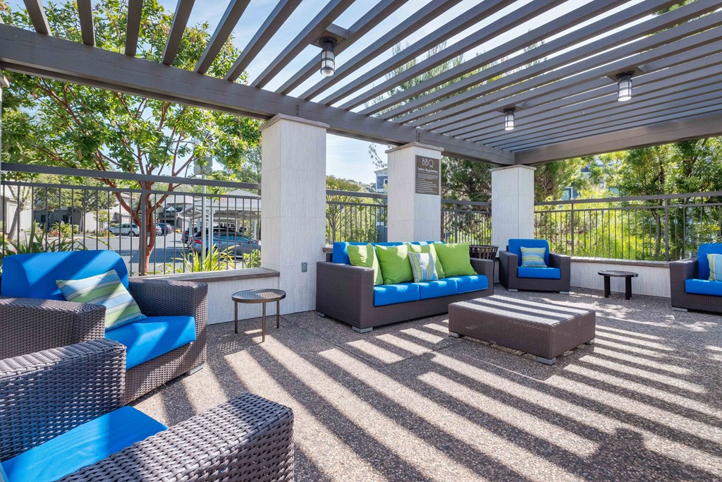 One Bedroom Apartments in Larkspur, CA - Larkspur Courts - Outdoor Covered Lounge with Brown Wicker Couches and Chairs with Blue Cushions