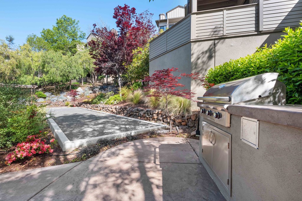 Larkspur Apartments - Larkspur Courts Apartments Outdoor Grill Area Surrounded by Beautiful Landscaping