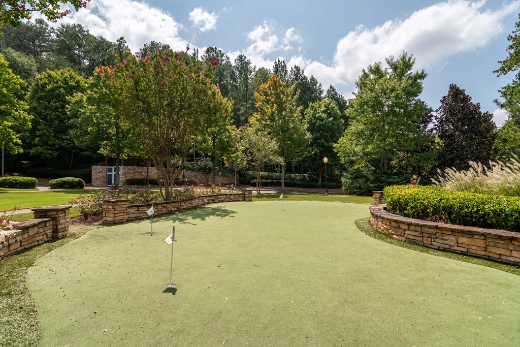 Woodstock, GA Apartments – Lea Woodstock – putting green area for golfing with trees in background
