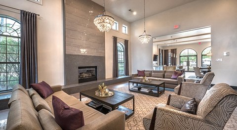 a living room with couches and chairs and a fireplace