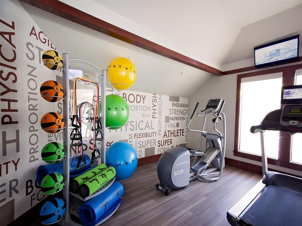 a workout room in a hotel gym with weights and a yoga ball