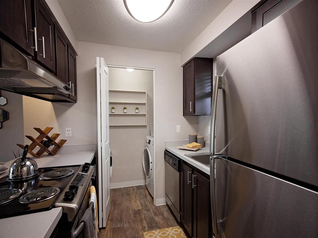 a kitchen with stainless steel appliances and a stainless steel refrigerator