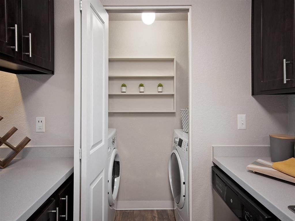 a laundry room with a washer and dryer and a sink