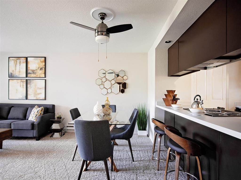 a living room and kitchen with a table and chairs