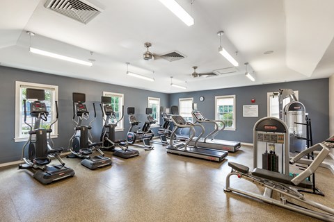 Marlborough, MA, Apartments Near Assabet River Rail Trail - Orchards Apartments - Fitness Center With Elliptical Machines, Treadmills, Stationary Bikes, Strength Equipment, Ceiling Fans, and Windows.