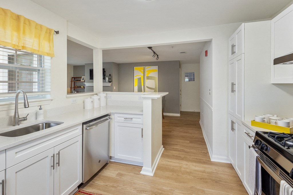 Orchards Apartments Marlborough ma apartment loft style apartments photo of kitchen stainless steel dishwasher and wood floors and white cabinets with dining room and living room with fireplace in background