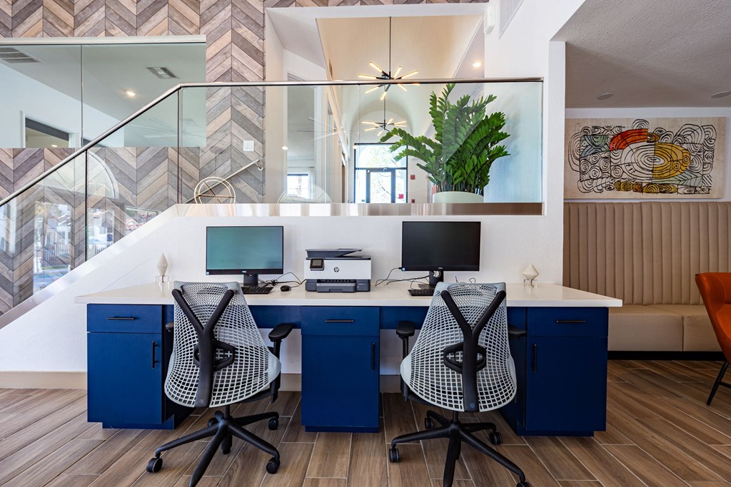 a home office with two desks and two computer monitors