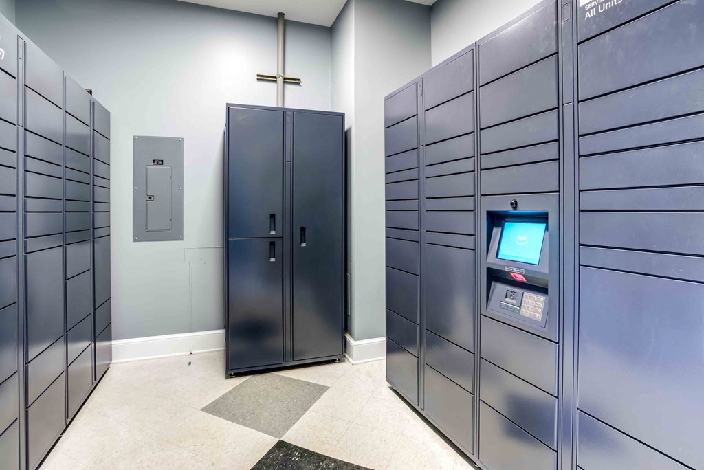 a row of industrial lockers in a room with a computer on the wall