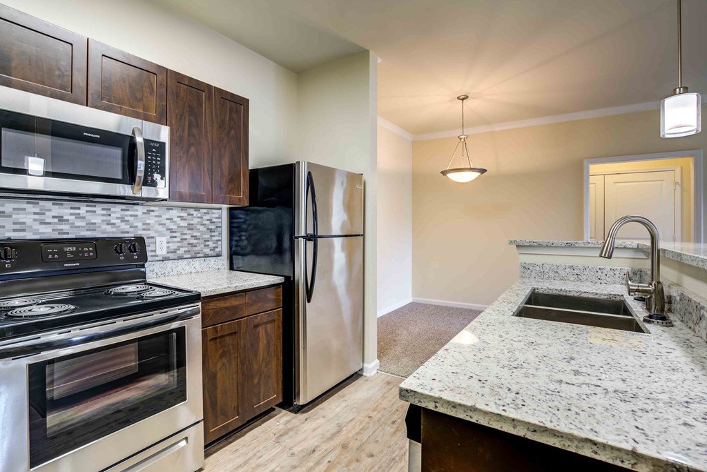 a kitchen with stainless steel appliances and granite counter tops