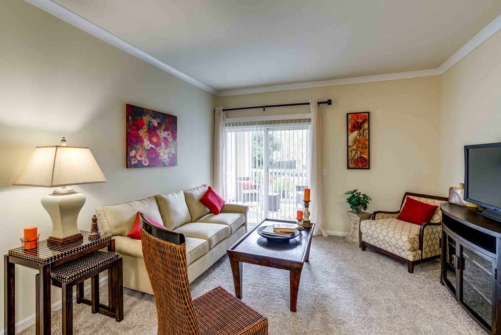a living room with a couch and chairs and a television