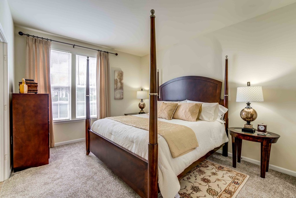 a bedroom with a four poster bed and a window