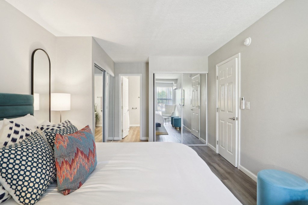 a bedroom with a large white bed and pillows