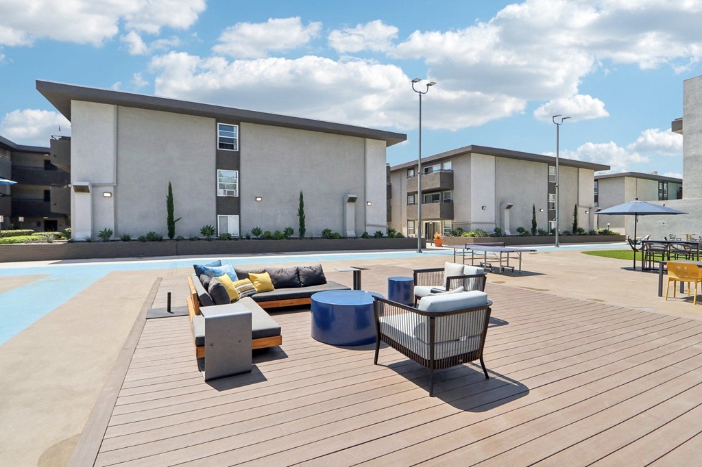 Dog-Friendly Apartments in Van Nuys, CA - San Regis - Outdoor Living Area with Hammocks, Cozy Seating Options, and Beautiful Landscaping