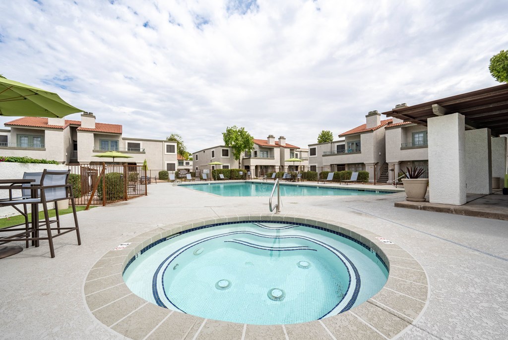 a swimming pool with apartments in the background