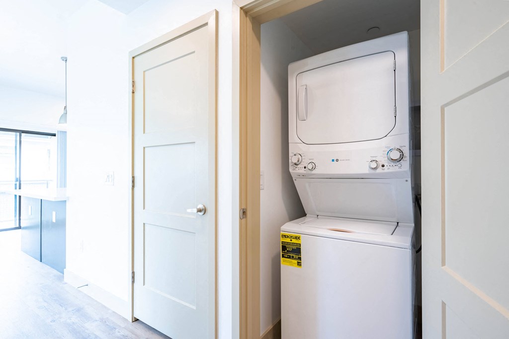 a white washer and dryer in a room next to a door