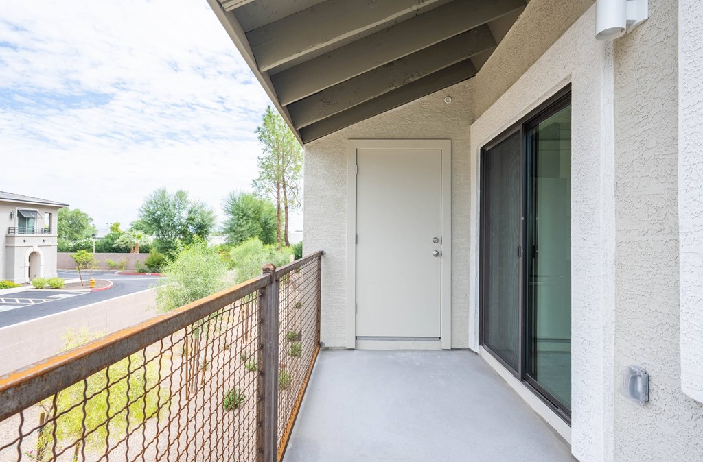the view from the balcony of an apartment building with a white door
