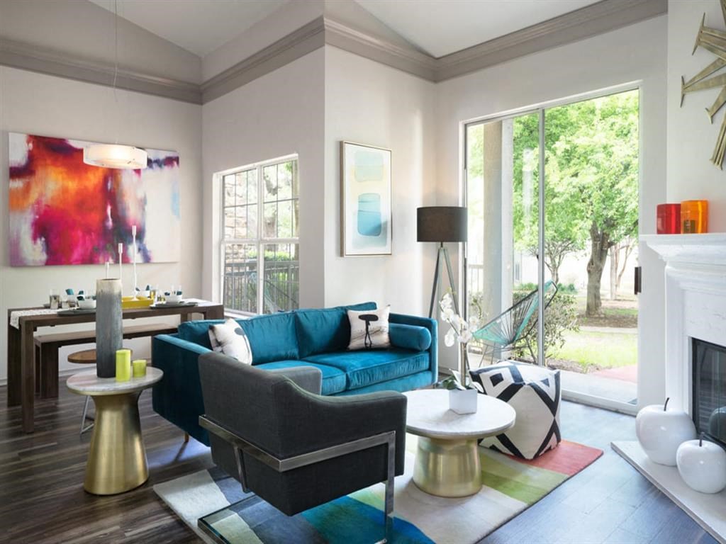 a living room with a blue couch and a fireplace