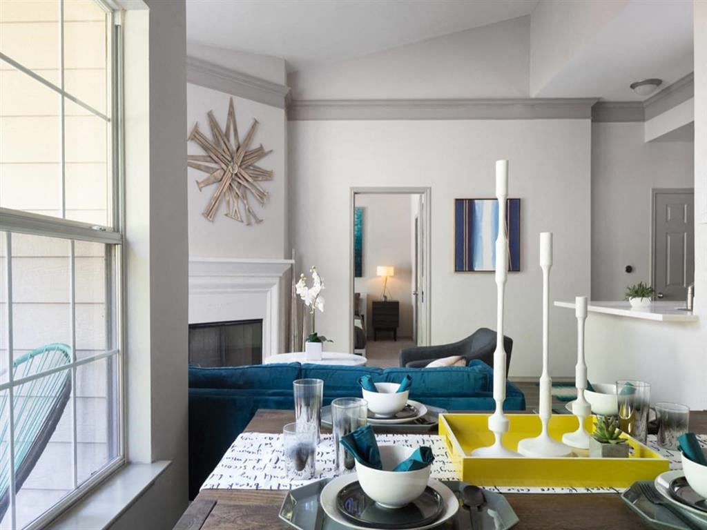 a living room with a blue couch and a table
