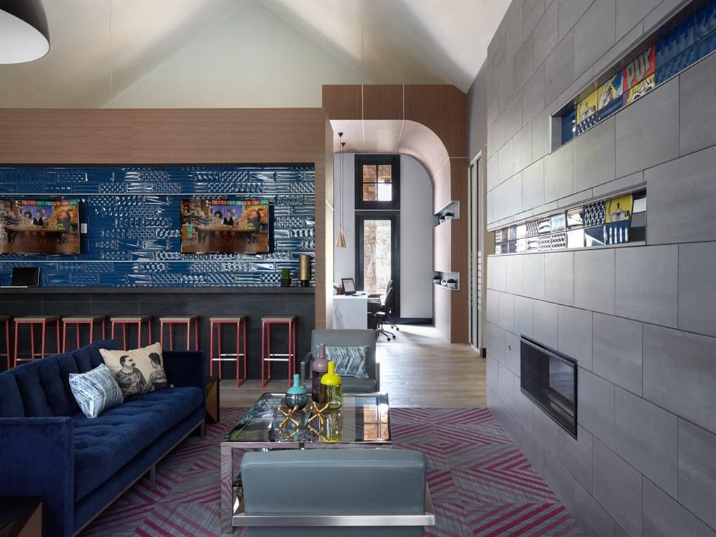 a living room with a blue couch and a fireplace