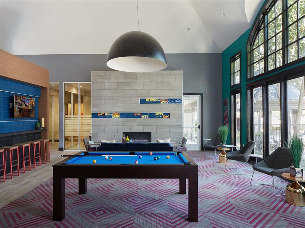 a pool table in a living room with a fireplace