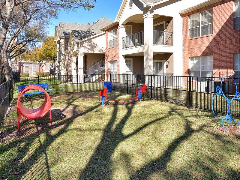 Plano Apartments for Rent - Carrington Park - Outside Pet Park with Jumping Hoops, Tunnel, and More Play Equipment