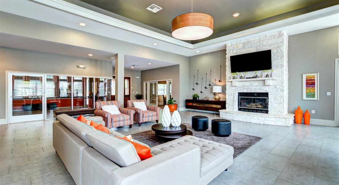 a large living room with couches and a fireplace