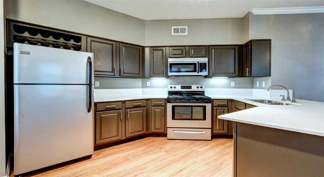 a kitchen with stainless steel appliances and wooden cabinets
