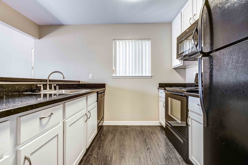 a kitchen with stainless steel appliances and white cabinets