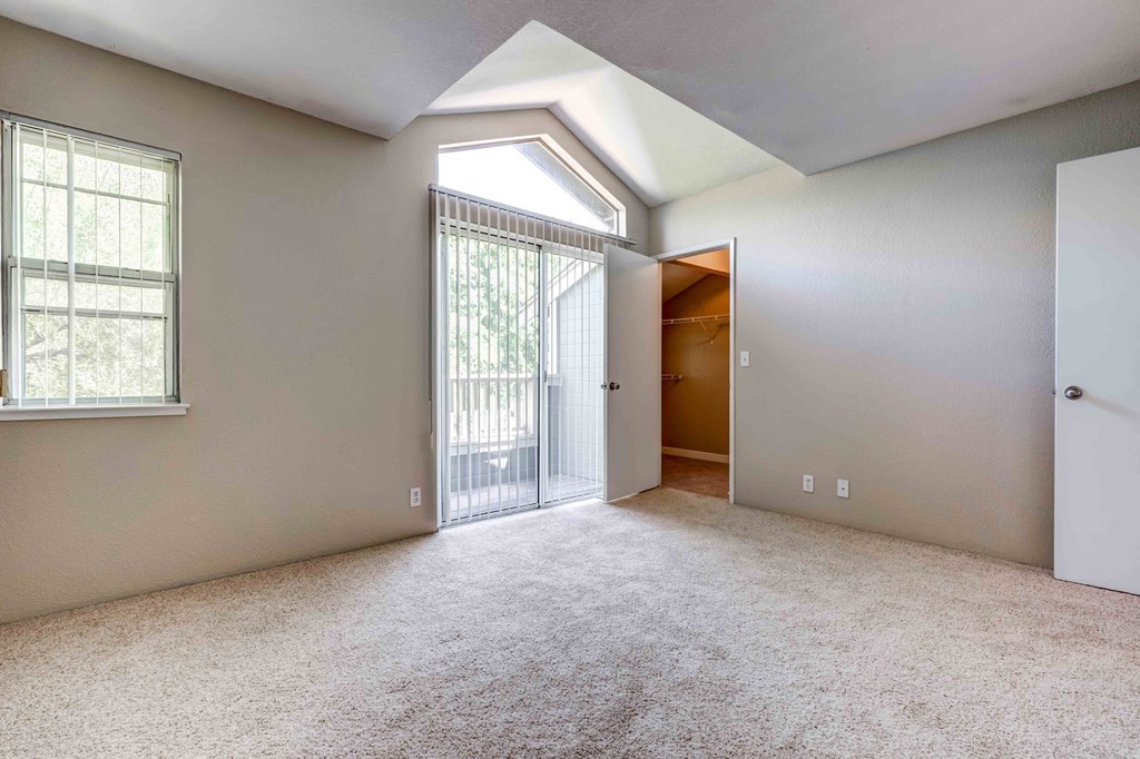 Apartments In San Jose, CA For Rent - Terra House - Spacious Bedroom With High Ceilings, Carpet Flooring, Large Closet, Window, And Access To Private Balcony
